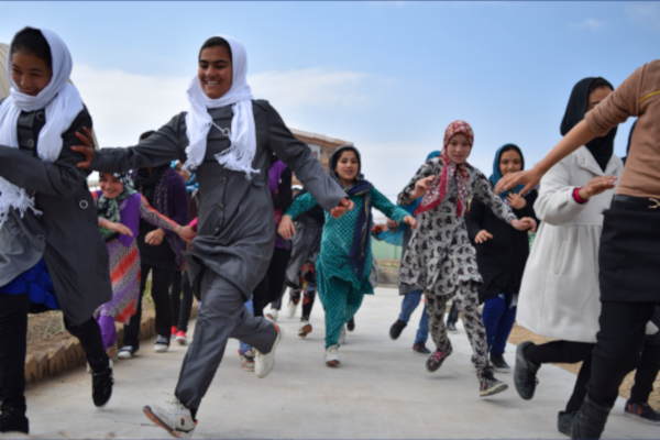 Afghan girls running towards the camera.