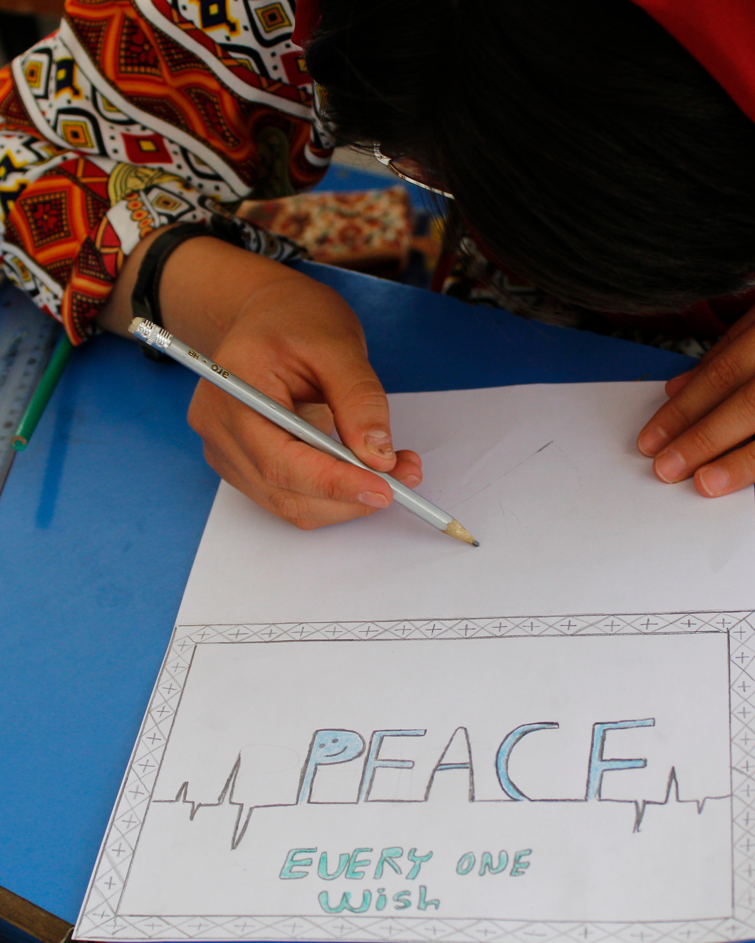 Afghan student writing.